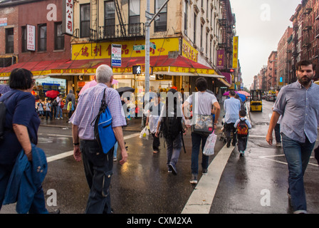 New York, NY, USA, Large Crowd People, Chinese Crossing on Rainy Street Corner in Chinatown, Lower East Side, Manhattan, Local neighbourhoods, urban walking, busy city street united states, nyc active streets Stock Photo