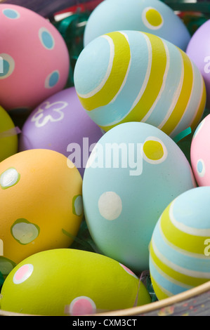 Brightly colored Easter eggs in a basket Stock Photo