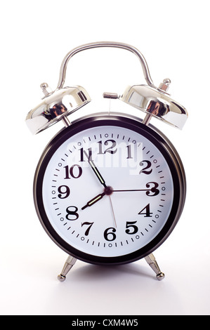 A black, vintage looking alarm clock on white background Stock Photo