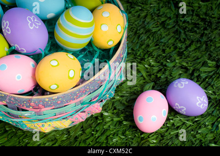 Brightly colored Easter eggs in a basket Stock Photo