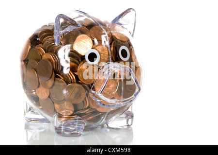 Clear plastic piggy bank stuffed full of pennies Stock Photo