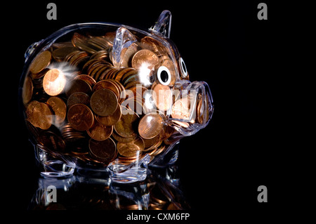 Clear plastic piggy bank full of American pennies Stock Photo