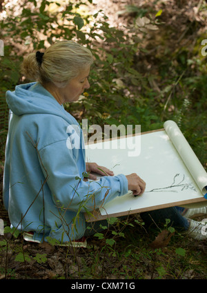 Charcoal art student drawing in forest at artist T.C. Steele's historic home.  Rural Brown County Indiana America Stock Photo