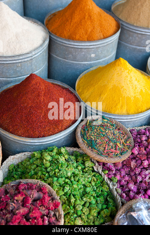 Bucket and and baskets with spices and dried herbs and flowers in market in Marrakesh, Morocco Stock Photo