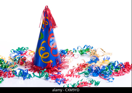 A brightly colored birthday hat and streamers on a white background with copy space Stock Photo