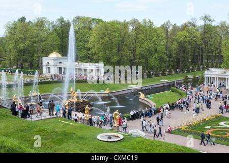 View of the Samson Fountain and people walking along alley the sea channel in Peterhof, Saint-Petersburg, Russia Stock Photo
