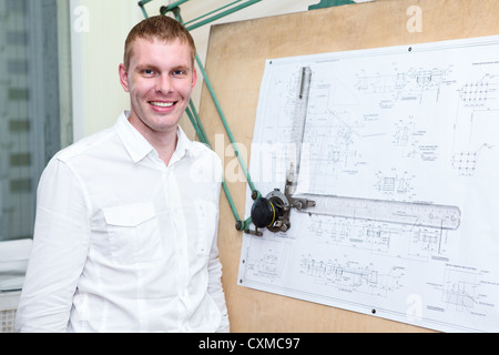 Handsome designer in the workplace near drawing board Stock Photo