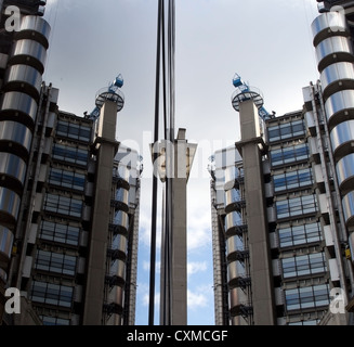 The London Lloyds building with its reflection in the windows opposite Stock Photo