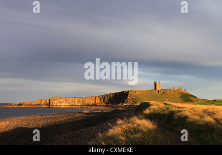 Dunstanburgh Castle at dusk. Stock Photo