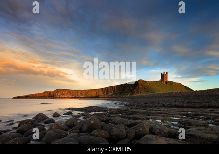 Dunstanburgh Castle at dusk. Stock Photo