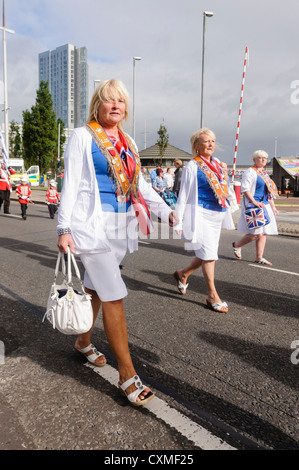 Women from a Ladies Loyal Orange Lodge marching during an Orange Order parade, with permission from the Orange Order Stock Photo