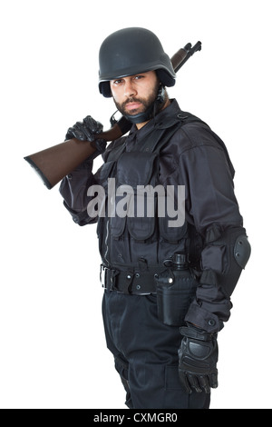 a swat agent wearing a bulletproof vest and aiming with a gun Stock Photo