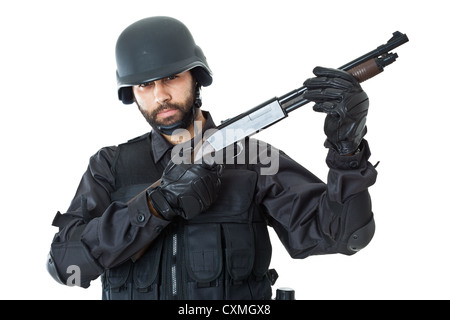 a swat agent wearing a bulletproof vest and aiming with a gun Stock Photo