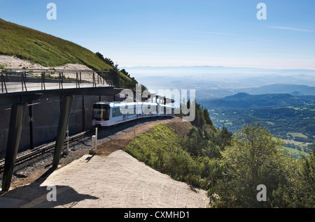 Tourist train going to the top of the Puy de Dome volcano in the Park Regional of Auvergne volcanoes, France Stock Photo