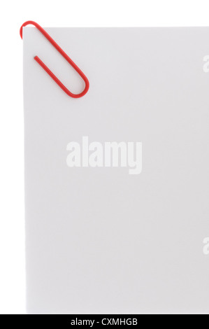 red paper clip on blank white sheet of paper with copy space Stock Photo