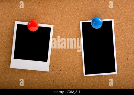 a set of photographs on a cork-board or bulletin board with a big red pin. clipping path for picture areas Stock Photo