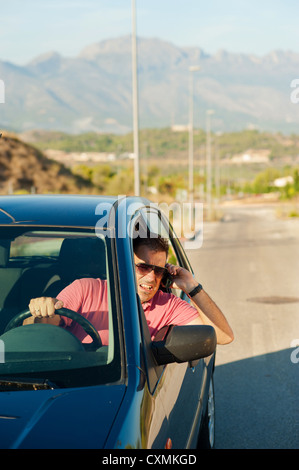 Aggressive guy yelling on the phone while driving Stock Photo