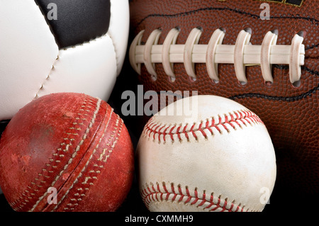 Assorted sports balls on a black background Stock Photo - Alamy