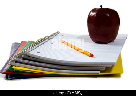 New school supplies on bright white background, with apple and pencil Stock Photo