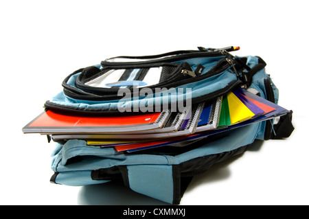 Blue backpack full of school supplies on a white background Stock Photo