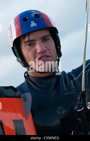 Portrait of a wet kitesurfer holding gear Stock Photo