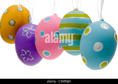 Row of pastel decorated Easter eggs hanging on a white background Stock Photo