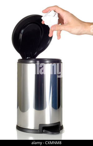Hand putting trash in a stainless steel trash can Stock Photo
