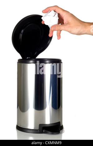 Hand putting trash in a stainless steel trash can Stock Photo