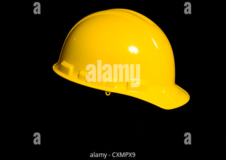 Yellow protective hard hat on black background Stock Photo