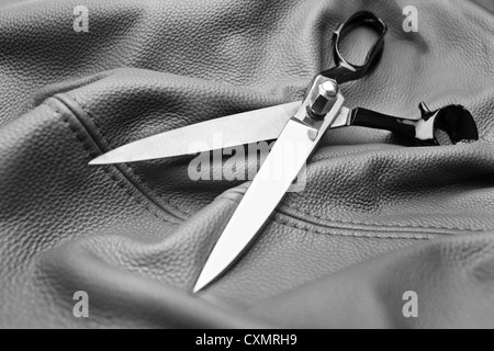 A scissors on a black leather background Stock Photo