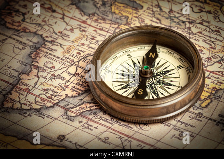 Old vintage retro brass compass on ancient map Stock Photo