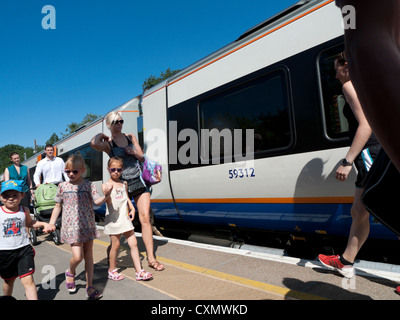 Family passengers walking on the Overground train platform at Gospel Oak station in summer attire London England UK  KATHY DEWITT Stock Photo