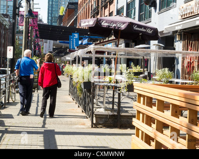 Mature Couple Strolling through Yaletown Neighborhood in Vancouver, Canada Stock Photo