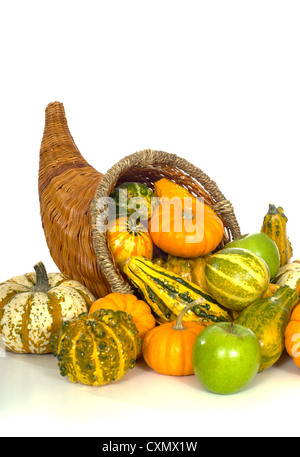 Cornucopia with fall harvest items including pumpkins, gourds, apples and Indian corn Stock Photo