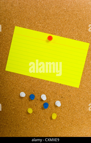 Bright, blank neon colored notecards on brown corkboard or bulletin ...