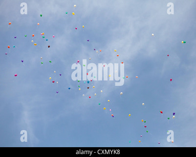 many colorful balloons fly high in the sky with white cloud in the  background during the party Stock Photo - Alamy