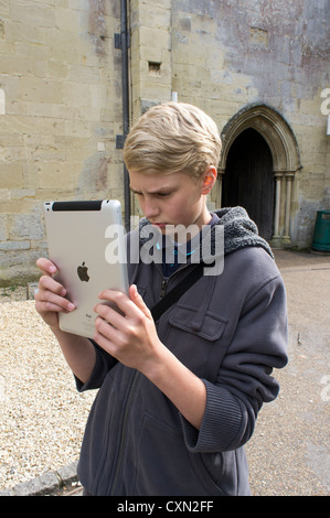 Young teenage boy with puzzled expression using an Apple iPad Stock Photo