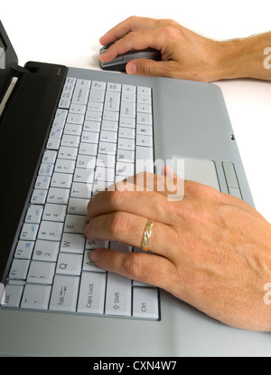 Set of male hands working on gray laptop computer Stock Photo