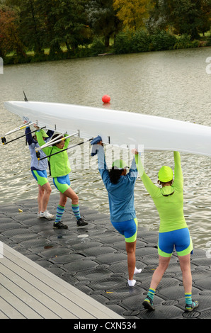 Quad team racing shell about to be set in water. Stock Photo