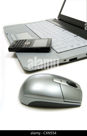 Business or personal productivity tools on white including a computer, mouse and cellular telephone includes path for screen Stock Photo