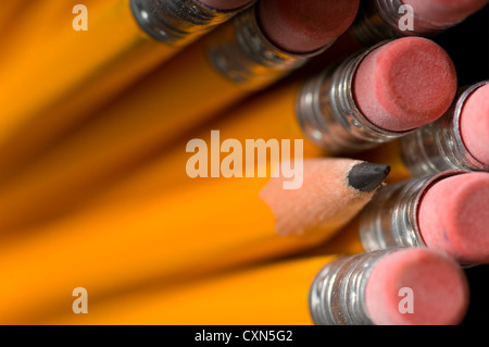 Macro shot of yellow pencils in pencil holder only the erasers and tip of the sharpened pencil are in focus Stock Photo