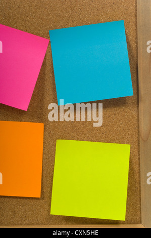 Blank colorful sticky notes or post-its on a cork board or bulletin board Stock Photo