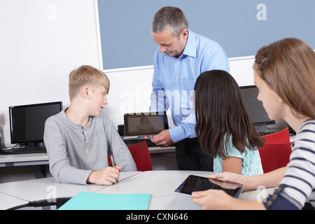 children using i pads in school lessons Stock Photo