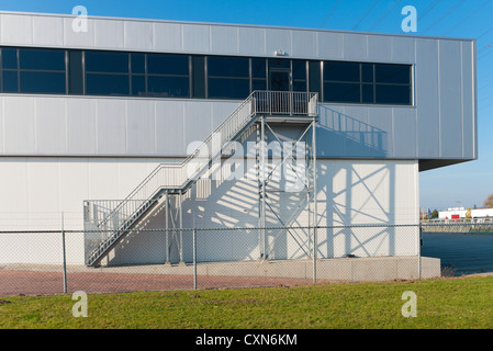 metal stairs on the outside of an industrial building Stock Photo