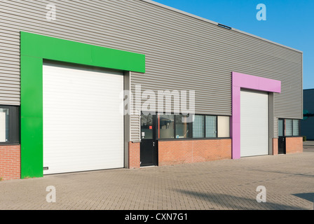 industrial warehouse with roller doors with different color accents Stock Photo