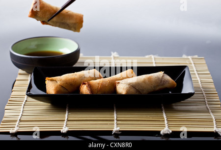 Spring rolls and dipping sauce shot in the studio Stock Photo