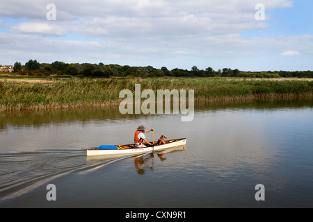 Man and Dog in Lifejackets Boating on the Alde at Snape Maltings Suffolk England Stock Photo