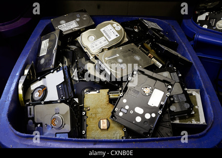 IT and computer disposal: Old hard drives and disks waiting for recycling at IT Disposal Ltd., Essex, UK Stock Photo