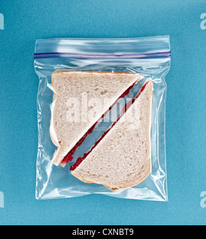 Jam Sandwich In a Resealable Plastic Bag on Blue Background Stock Photo