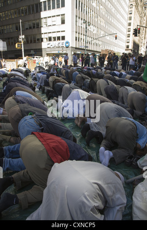 Annual Muslim American Day Parade on Madison Avenue in New York City. Men pray on Madison Ave. before the parade begins. Stock Photo